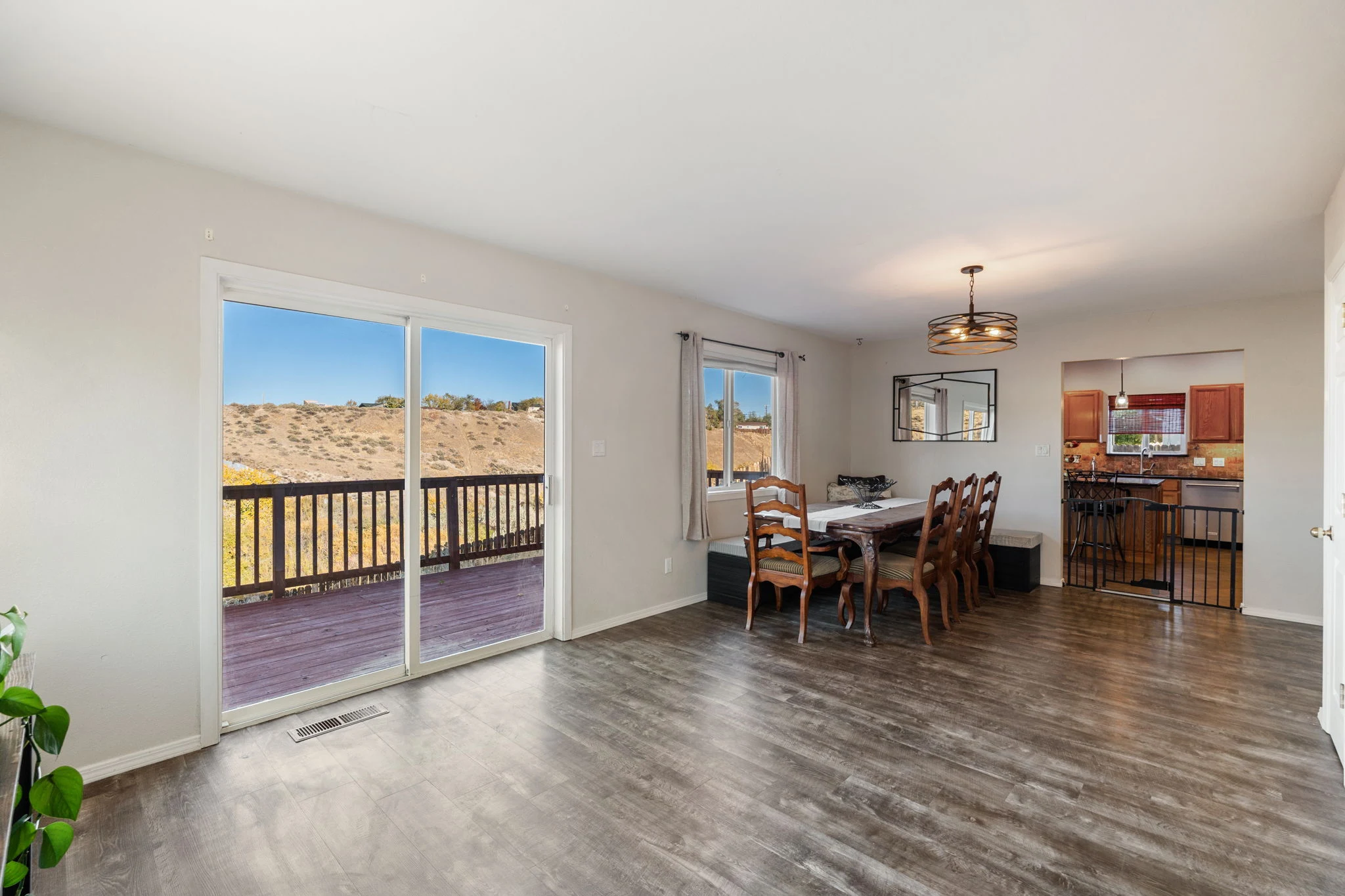 Rear family room currently arranged for dining, opening to the deck
