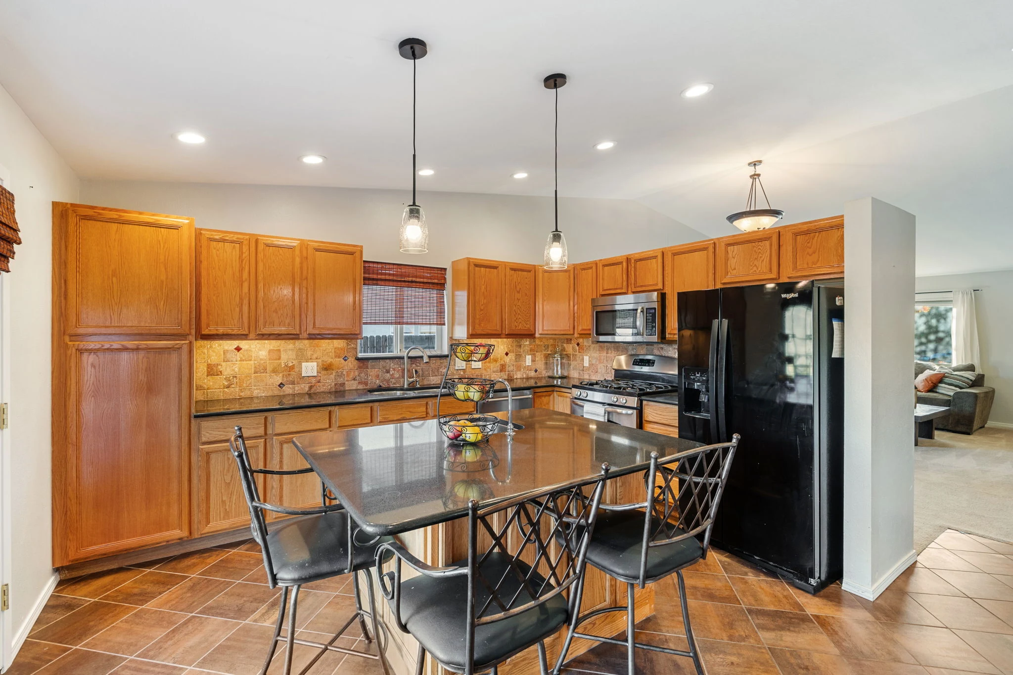 Kitchen with island and granite counters